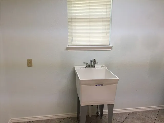 a white bath tub sitting next to a toilet