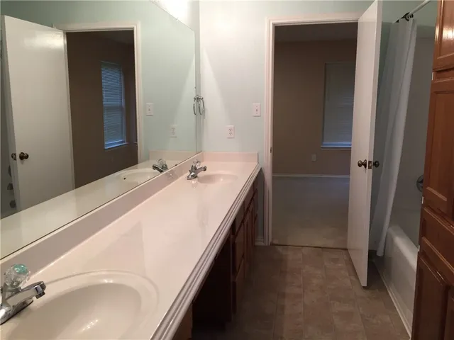 a bathroom with a sink vanity mirror and toilet