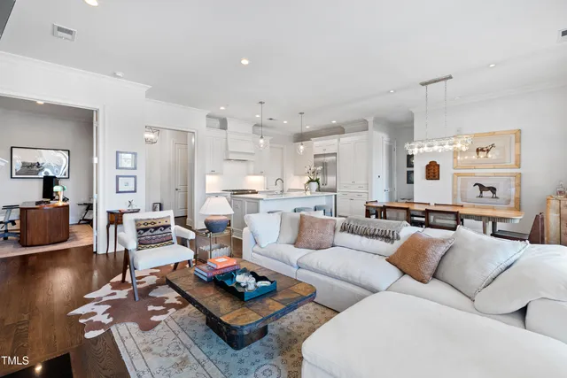 a living room with furniture kitchen view and a table