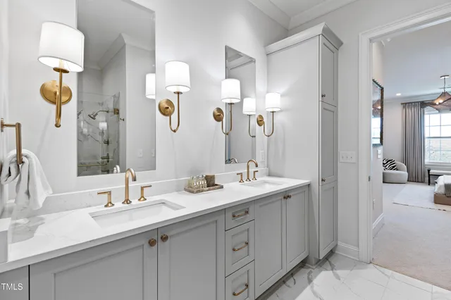 a bathroom with a sink double vanity granite and a mirror