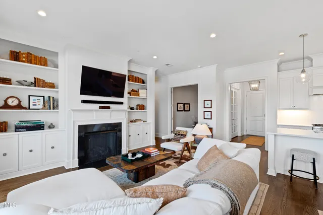 a living room with furniture a fireplace and a flat screen tv