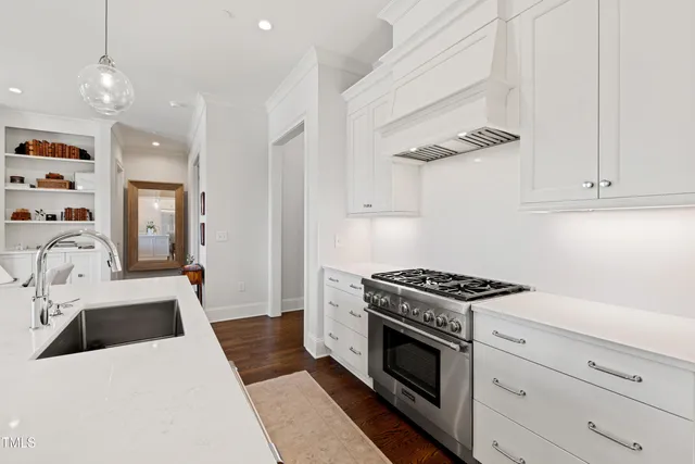 a kitchen with a stove and white cabinets
