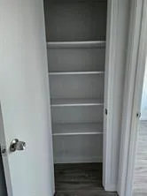 a view of walk in closet with empty racks