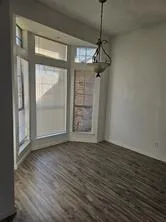a view of a room with wooden floor exposed radiator and closet
