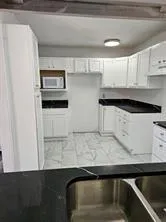 a kitchen with stainless steel appliances a sink and cabinets