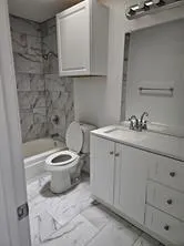 a bathroom with a sink a toilet and mirror