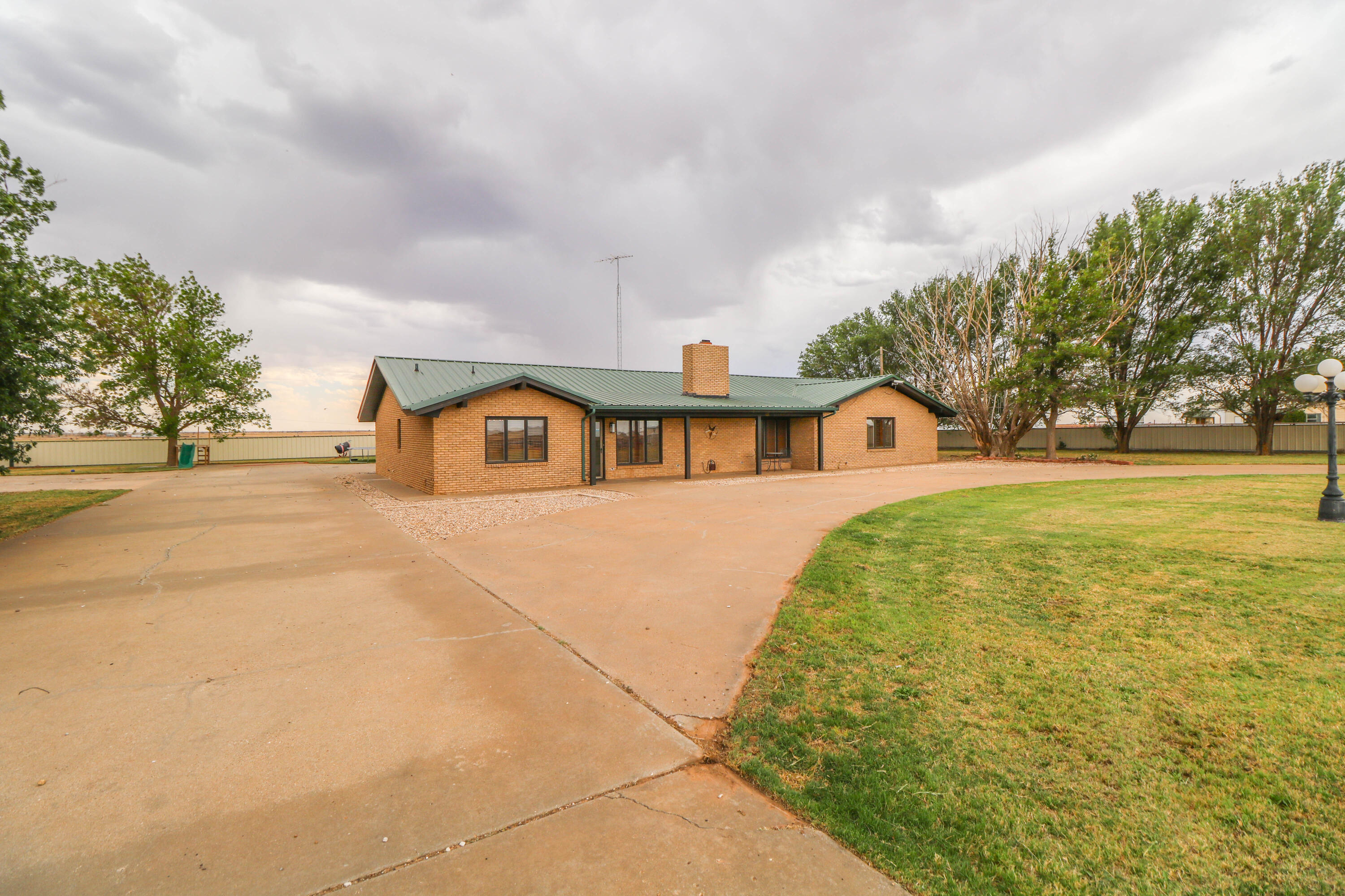 1740 Highway 70 Springlake, TX 79082 - Photo 28 of 39 a house view with swimming pool and trees in the background