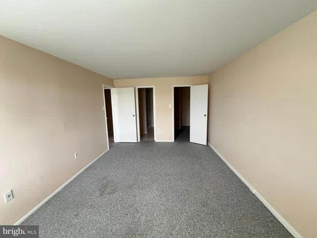 a view of walk in closet with clothes