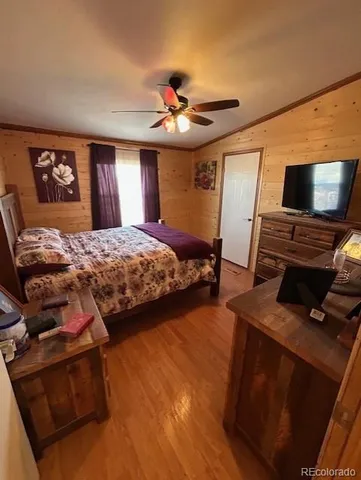 a bedroom with bed and flat screen tv