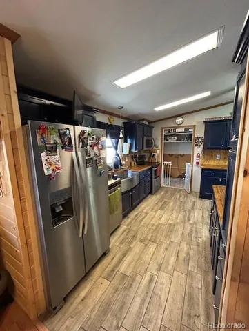 a kitchen with refrigerator and window