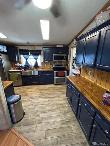 a large kitchen with stainless steel appliances kitchen island granite countertop a large counter top