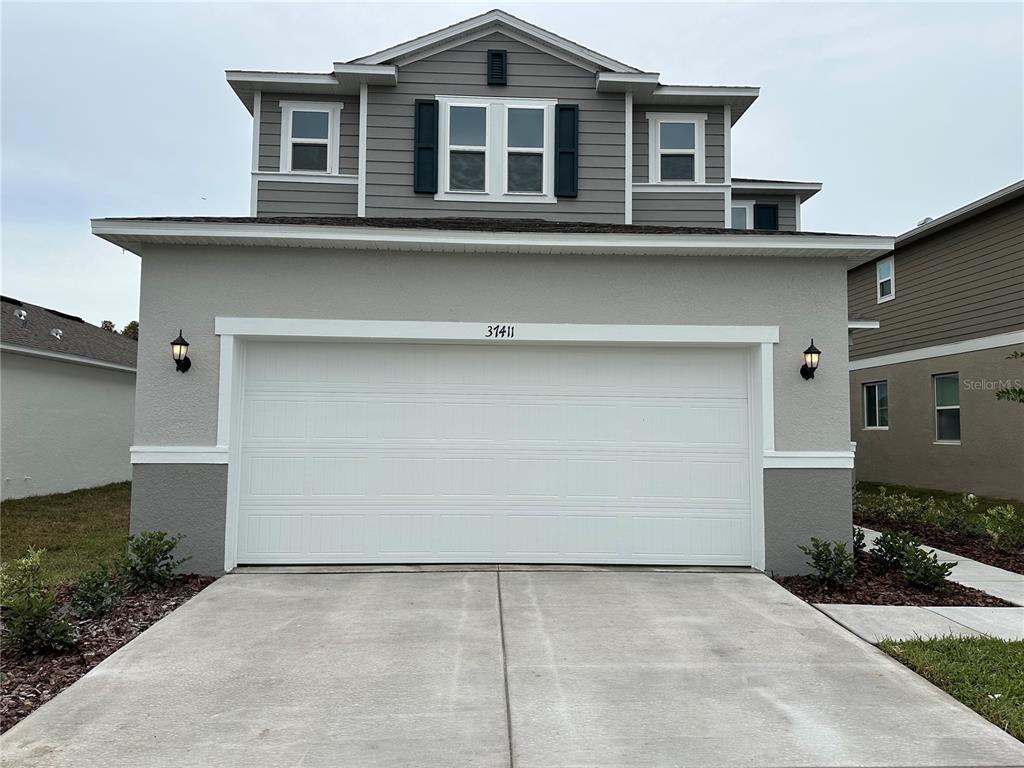 a front view of a house with garage