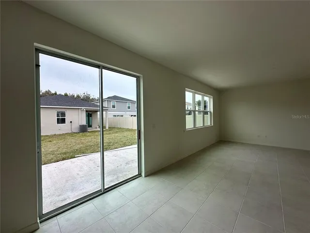 a bathroom with a granite countertop sink a toilet a mirror and shower