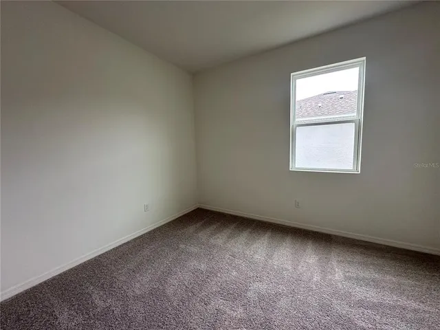 a bathroom with a granite countertop double vanity sink toilet mirror and shower