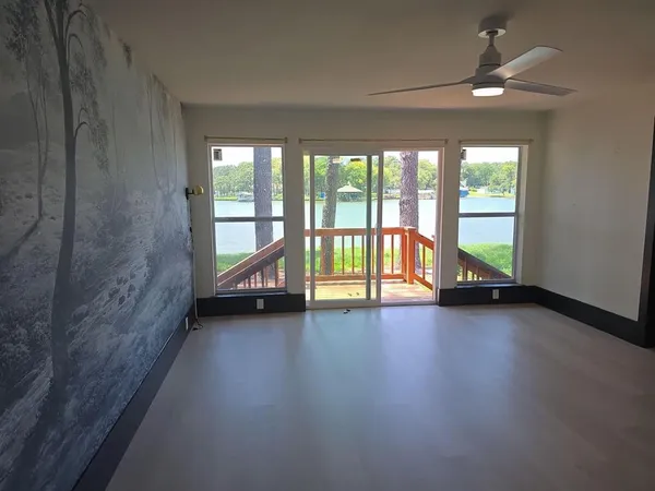 a view of an empty room with large windows