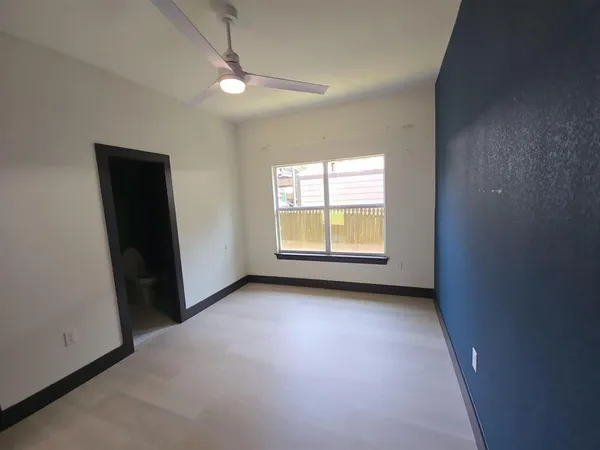 an empty room with windows and closet
