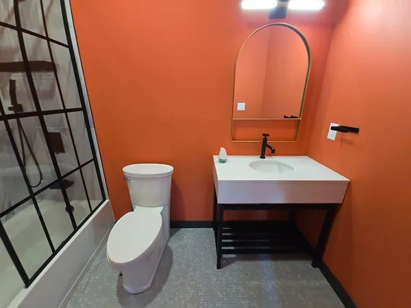 a bathroom with a toilet a sink and a mirror