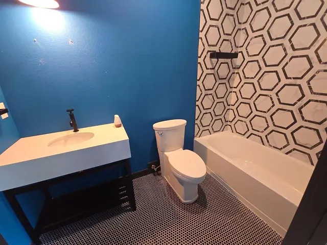 a bathroom with a toilet and a sink