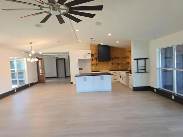 a large kitchen with cabinets and stainless steel appliances