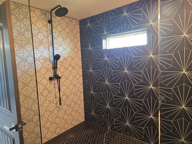 a bathroom with a shower and a shower
