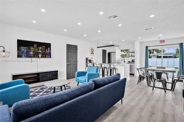 a living room with furniture and wooden floor