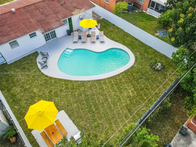 a view of a swimming pool with a chair and tables