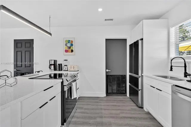 a kitchen with a sink and a refrigerator