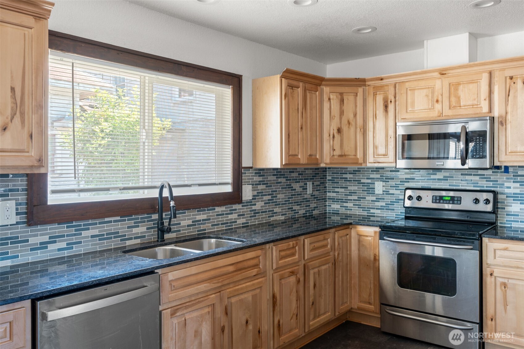 226 Southwest Lewis Street Chehalis, WA 98532 - Photo 15 of 27 a kitchen with granite countertop a sink and a stove