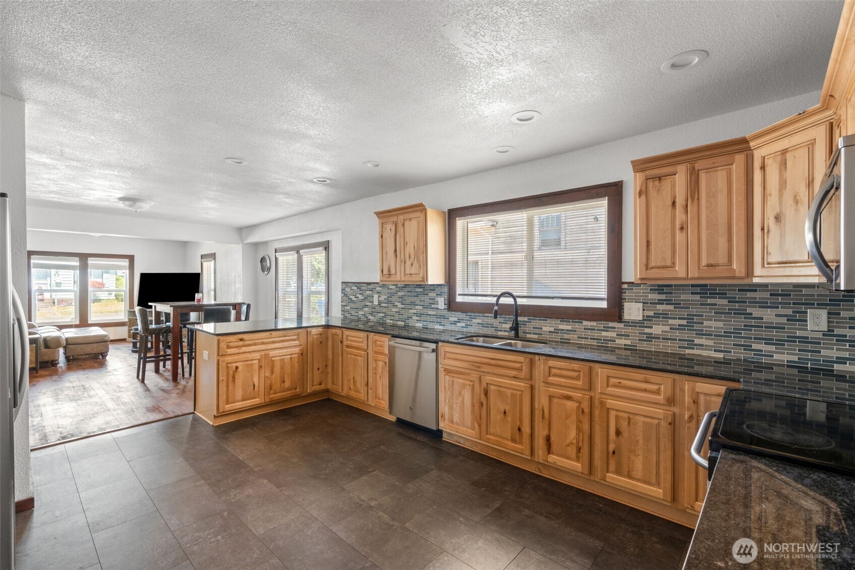 226 Southwest Lewis Street Chehalis, WA 98532 - Photo 16 of 27 a open kitchen with granite countertop a sink dishwasher stove top oven and cabinets