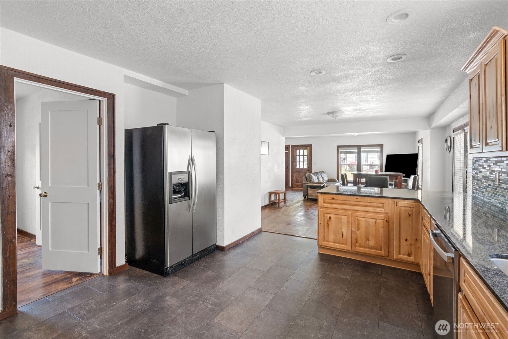226 Southwest Lewis Street Chehalis, WA 98532 - Photo 17 of 27 a large white kitchen with stainless steel appliances granite countertop a refrigerator and a stove top oven