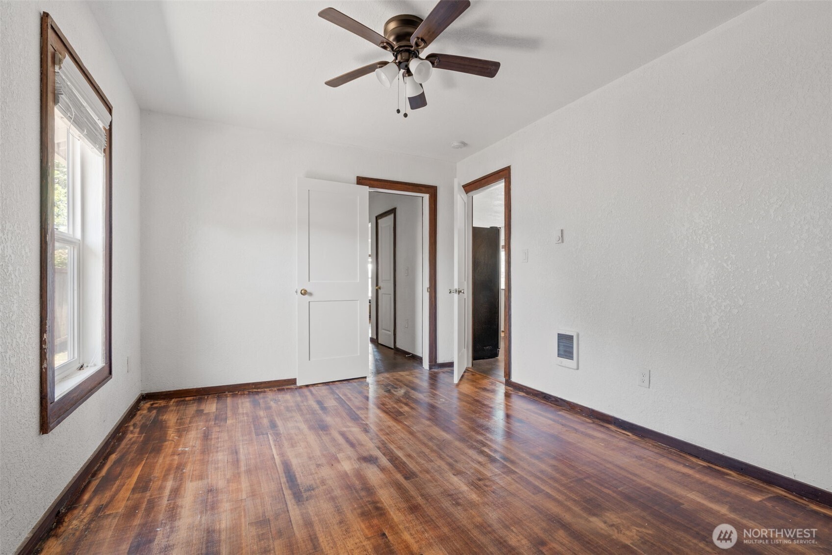 226 Southwest Lewis Street Chehalis, WA 98532 - Photo 19 of 27 a view of a room with wooden floor and a ceiling fan