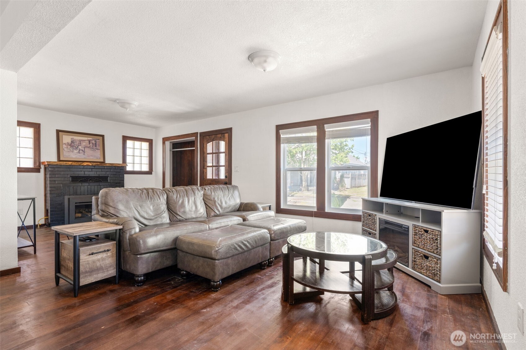 226 Southwest Lewis Street Chehalis, WA 98532 - Photo 6 of 27 a living room with furniture a flat screen tv and a fireplace