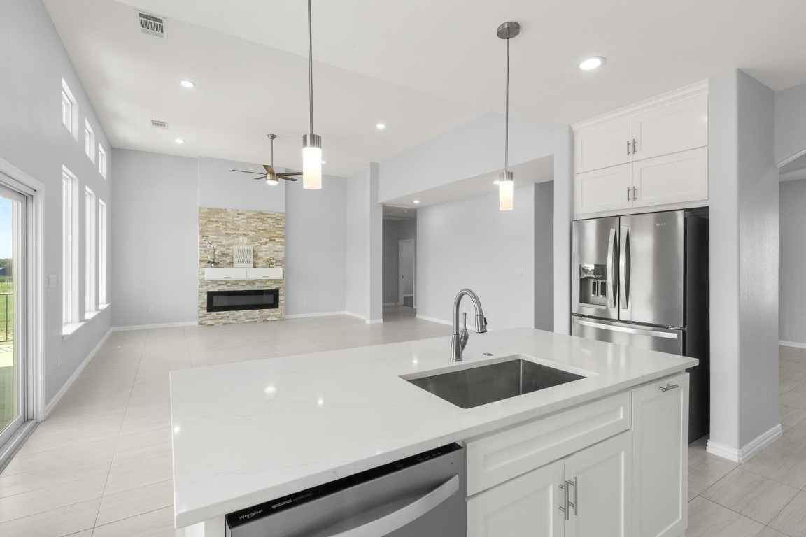 1136 County Road 484 Elgin, TX 78621 - Photo 13 of 37 Kitchen with stainless steel appliances, ceiling fan, decorative light fixtures, white cabinetry, and recessed lighting