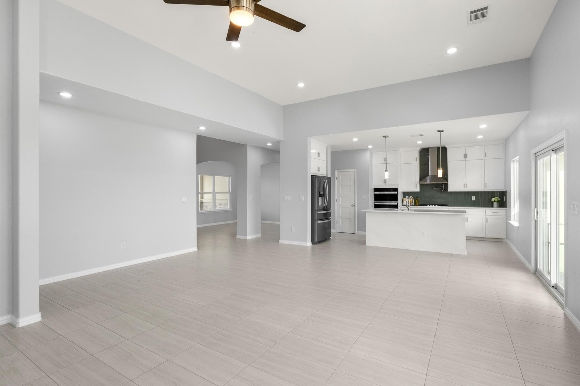 1136 County Road 484 Elgin, TX 78621 - Photo 15 of 37 Unfurnished living room featuring a ceiling fan, recessed lighting, and arched walkways