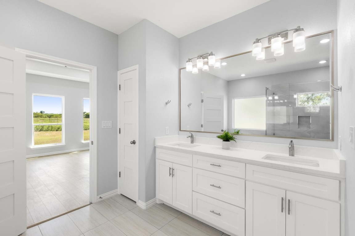 1136 County Road 484 Elgin, TX 78621 - Photo 21 of 37 Full bathroom featuring double vanity and a shower stall