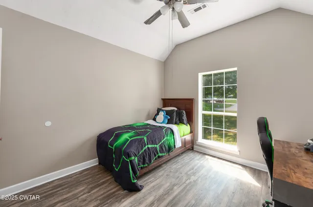 a bedroom with a bed and a window