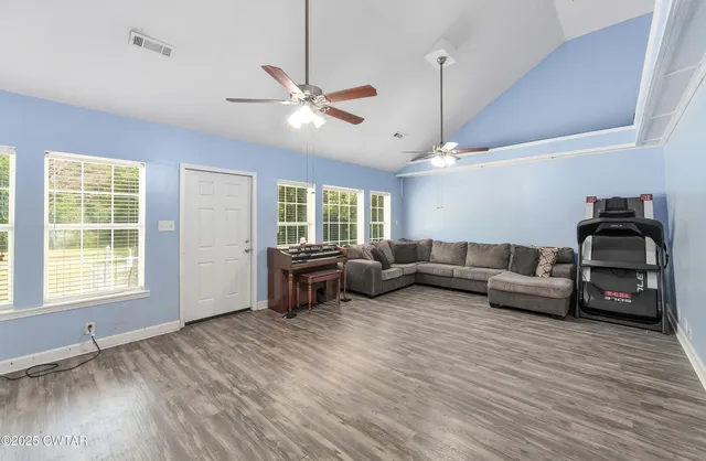 a living room with furniture and wooden floor