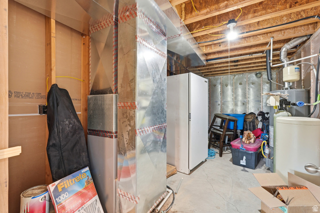 306 Spring Road Preston, ID 83263 - Photo 32 of 55 Unfinished basement area featuring exposed ceiling joists, ductwork, and utility installations including a water heater and water softener