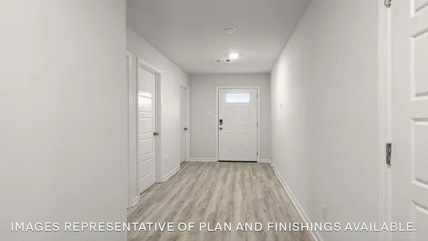 a view of hallway with wooden floor