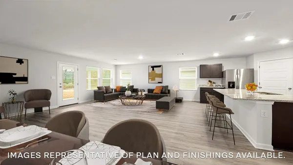 a living room with furniture a large window and wooden floor