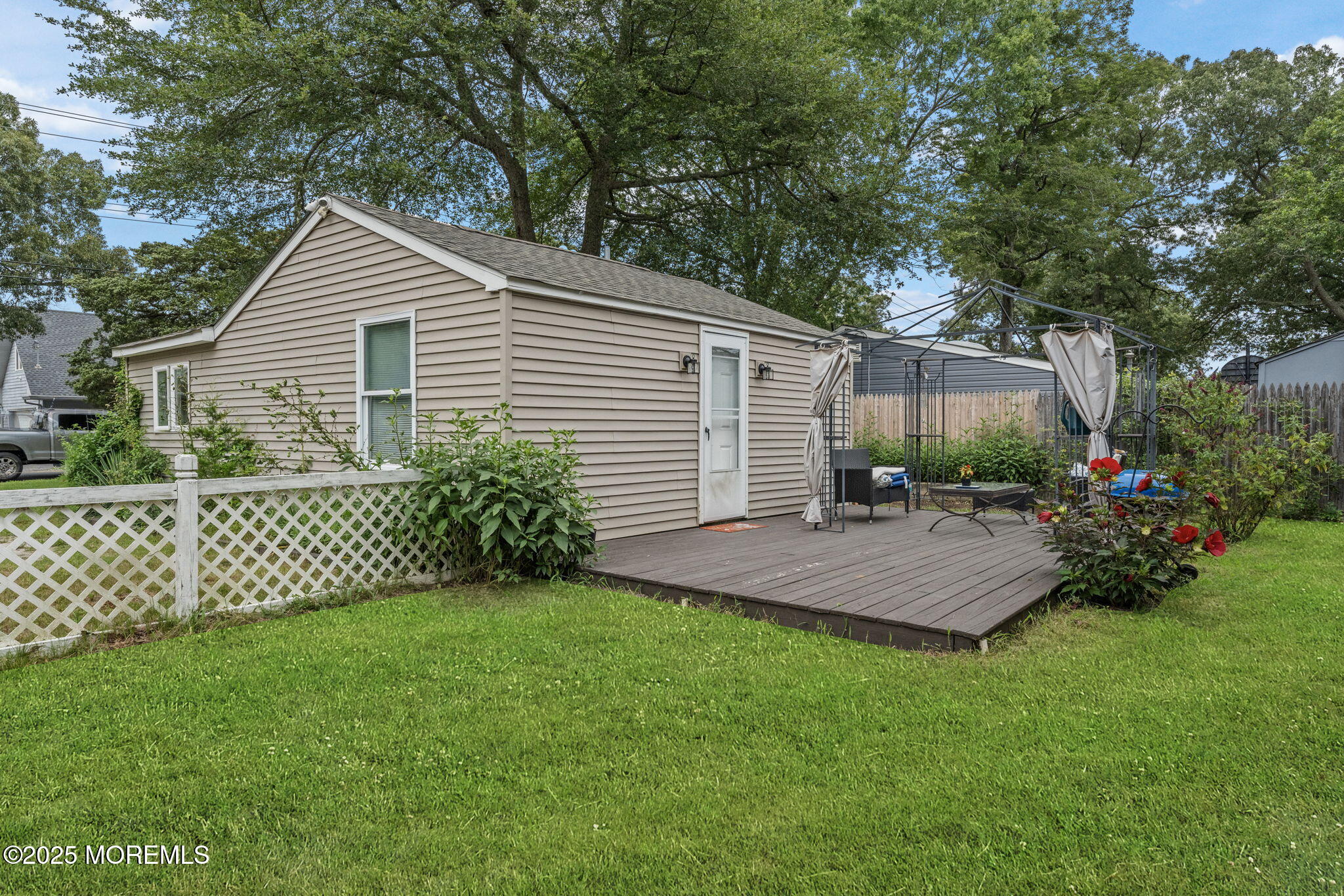809 Beach Boulevard Forked River, NJ 08731 - Photo 5 of 16 a front view of a house with a yard and outdoor seating
