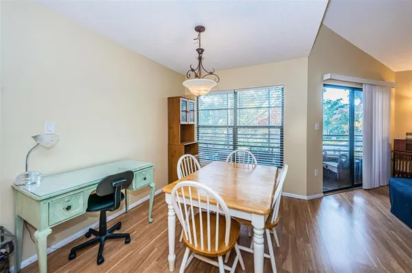 a view of a dining room with furniture window and wooden floor