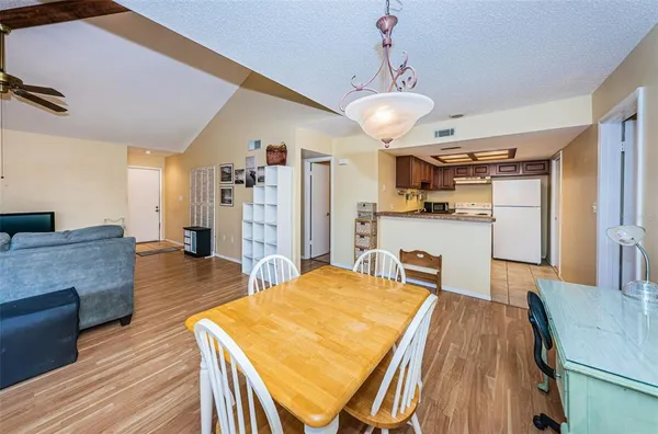 a open kitchen with kitchen island a stove and a refrigerator