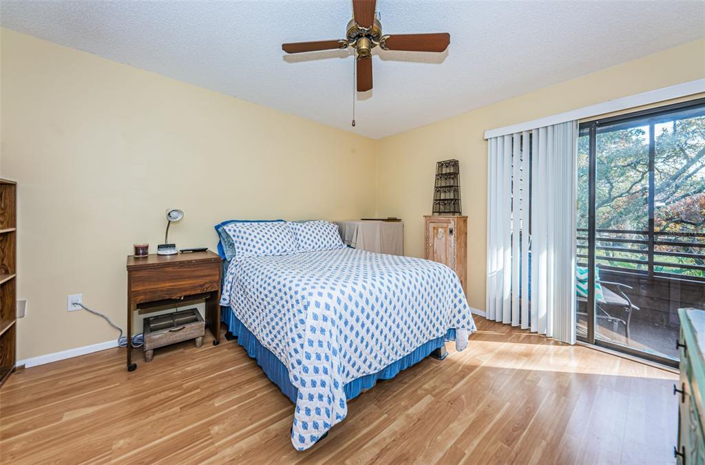 802 Lennox Road West, Unit 802 Palm Harbor, FL 34683 - Photo 14 of 42 a bedroom with a bed and wooden floor