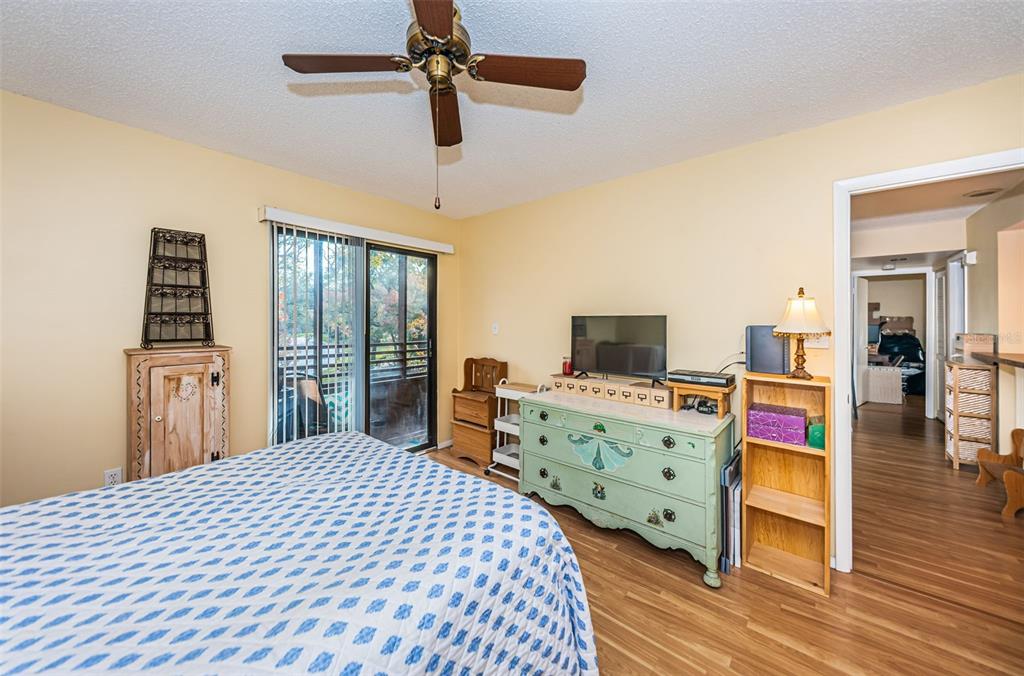 802 Lennox Road West, Unit 802 Palm Harbor, FL 34683 - Photo 15 of 42 a bedroom with a bed and a flat tv screen on dresser