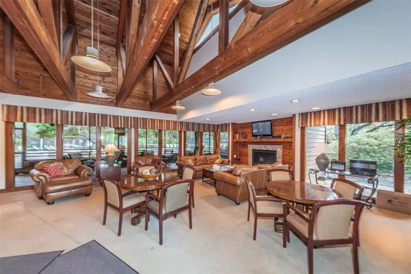 a living room with furniture a fireplace and a large window