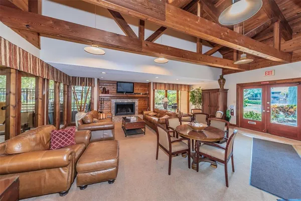 a living room with furniture a large window and a fireplace