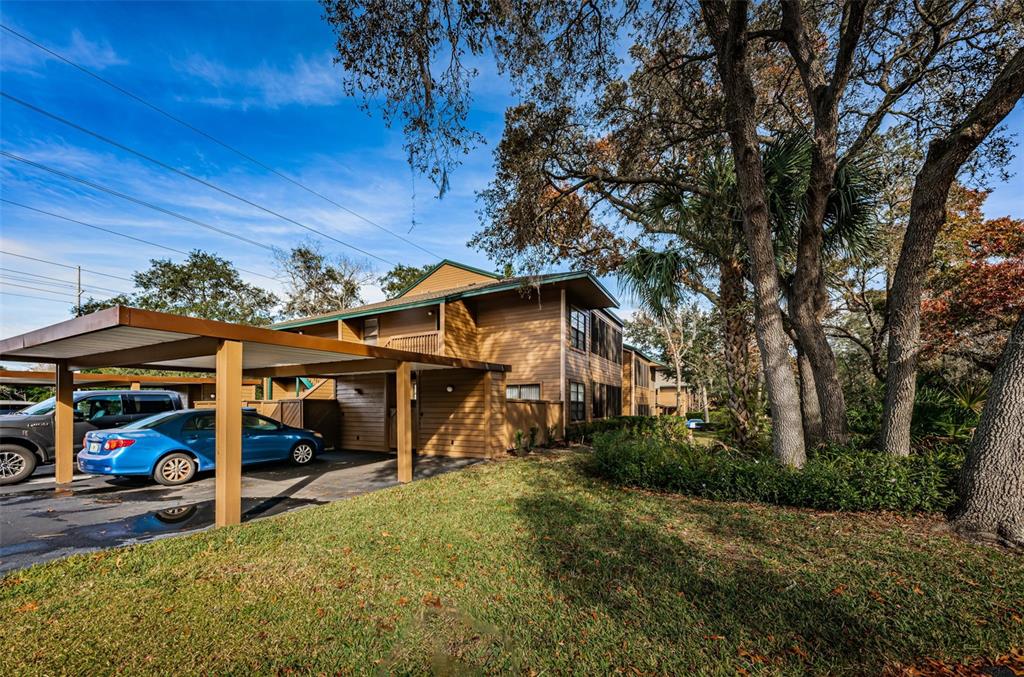 802 Lennox Road West, Unit 802 Palm Harbor, FL 34683 - Photo 3 of 42 a view of a park with table and chairs under an umbrella