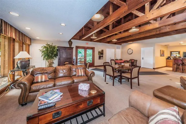 a kitchen with stainless steel appliances kitchen island granite countertop a table and chairs in it