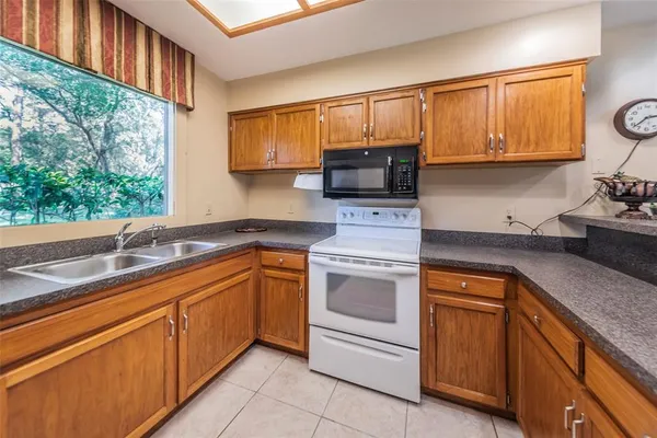 a dining room with furniture water view and a floor to ceiling window